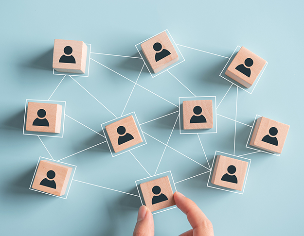 Building a strong team, Wooden blocks with people icon on pink background, Human resources and management concept.